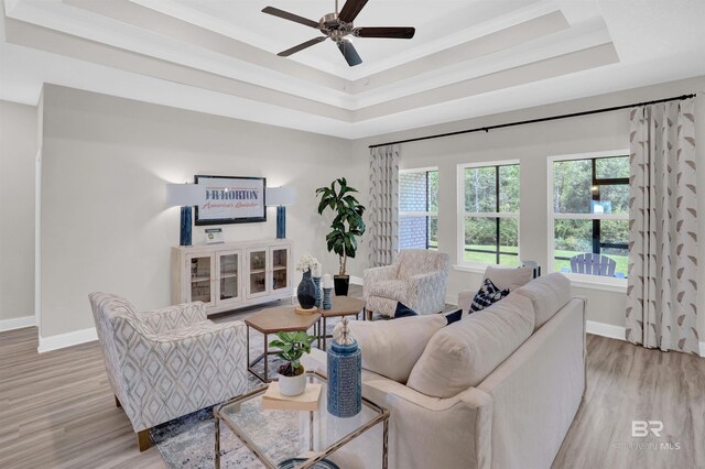12753 Shoshoney Cir, Fairhope, AL 36532 - living room with light wood-style flooring, baseboards, a raised ceiling, and ceiling fan