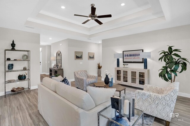 12753 Shoshoney Cir, Fairhope, AL 36532 - living room featuring ceiling fan, baseboards, a raised ceiling, and wood finished floors