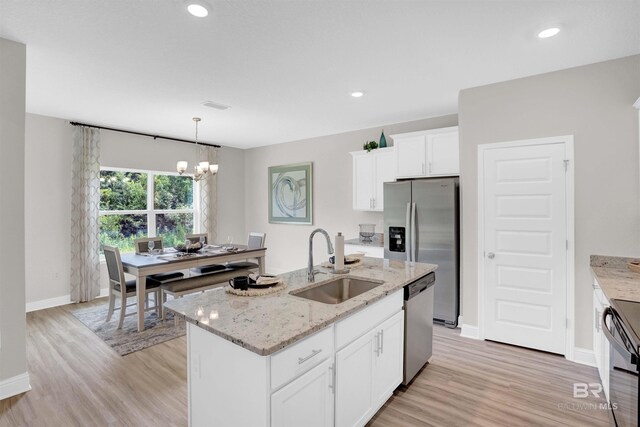 12753 Shoshoney Cir, Fairhope, AL 36532 - kitchen with a sink, light wood-style floors, appliances with stainless steel finishes, and white cabinets