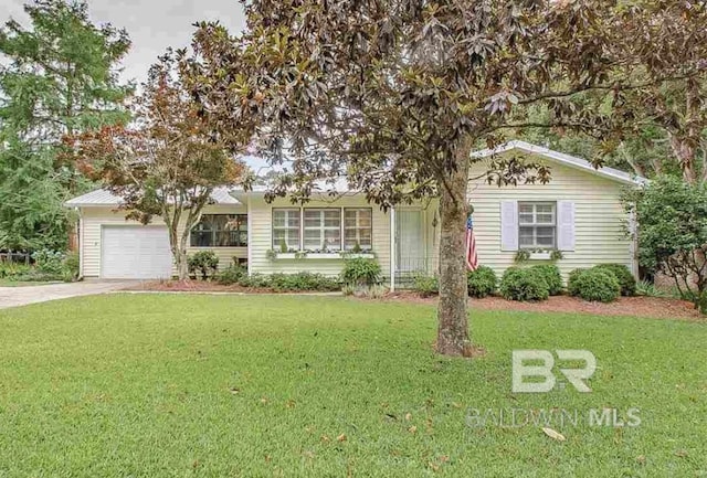 view of front of property featuring a garage and a front lawn