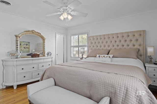 bedroom with crown molding, ceiling fan, and light hardwood / wood-style floors