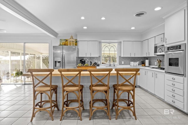 kitchen with a center island, white cabinets, and appliances with stainless steel finishes