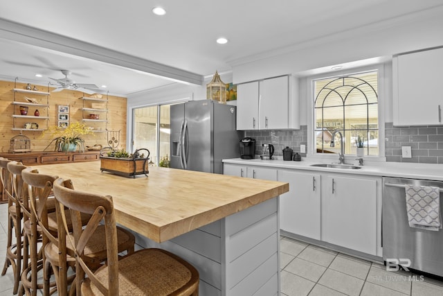 kitchen with stainless steel appliances, white cabinetry, and sink