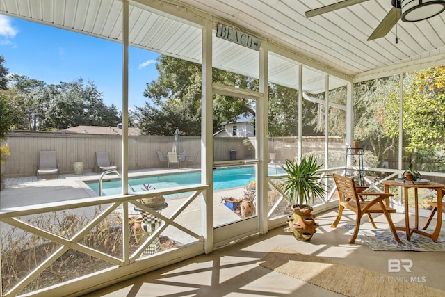 unfurnished sunroom featuring ceiling fan