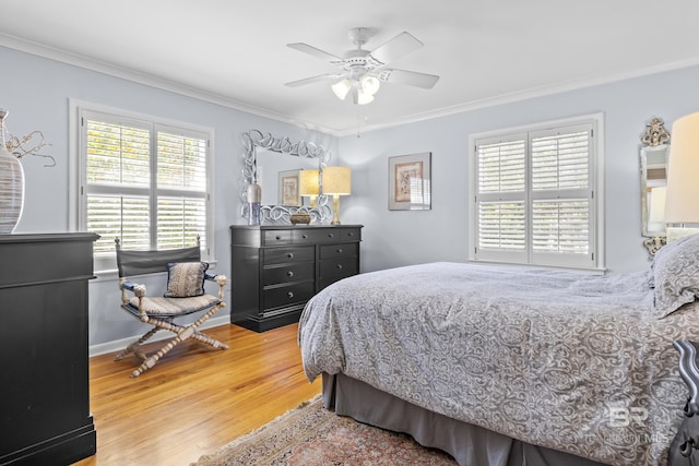 bedroom with crown molding, ceiling fan, and hardwood / wood-style floors