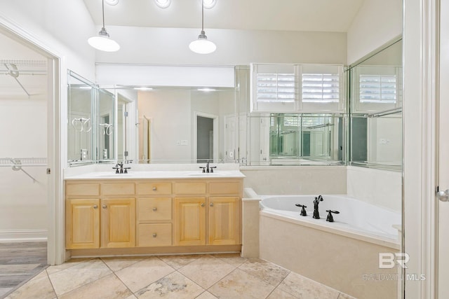 bathroom featuring vanity, tile patterned floors, and a bathtub