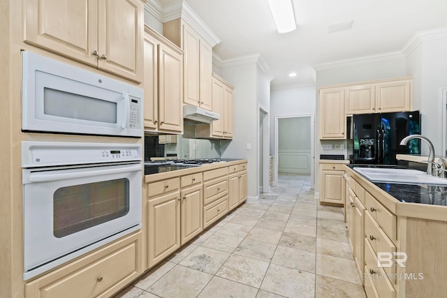 kitchen with white appliances, sink, light tile patterned floors, ornamental molding, and light brown cabinetry