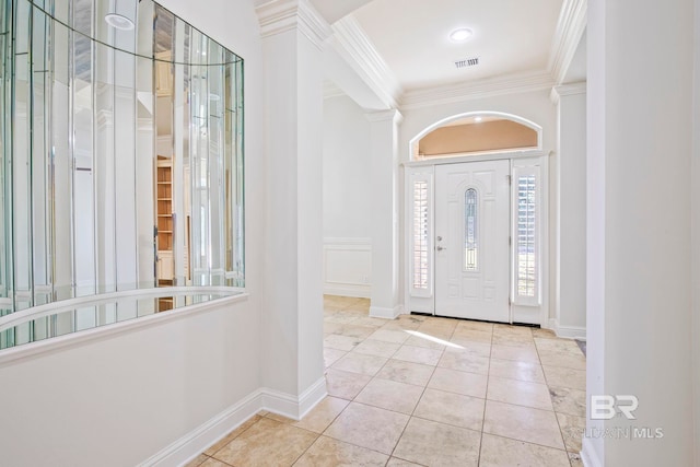 foyer entrance with light tile patterned floors and ornamental molding