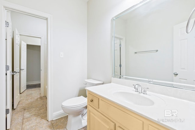 bathroom featuring tile patterned floors, vanity, and toilet