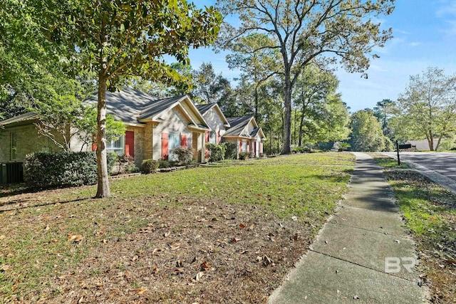 view of front of property with a front yard and central AC