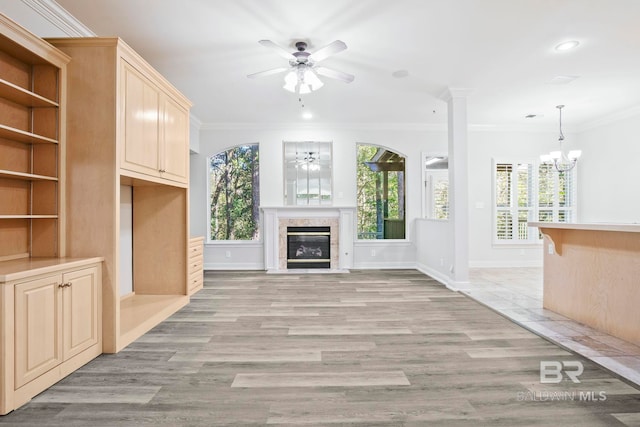 13 Bugle Retreat, Spanish Fort, AL 36527 - unfurnished living room with ceiling fan, crown molding, a fireplace with flush hearth, a chandelier, and light wood-style flooring