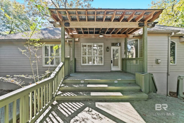 exterior space with ceiling fan and a deck