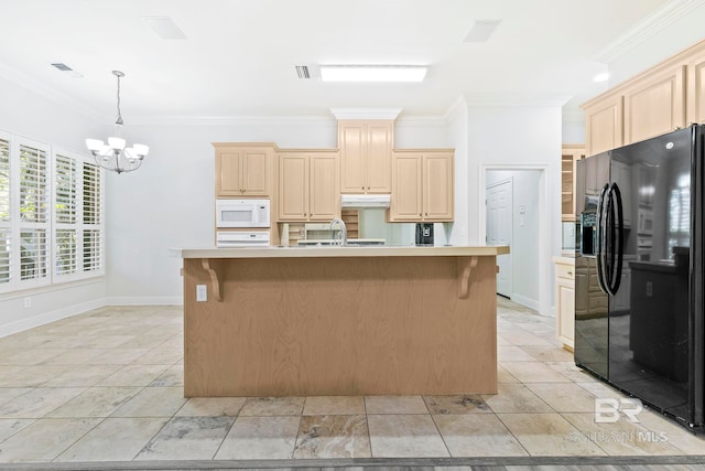 kitchen with an inviting chandelier, black fridge, a kitchen island with sink, and ornamental molding