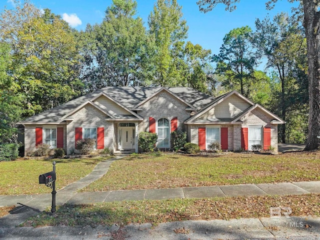 ranch-style home with a front lawn