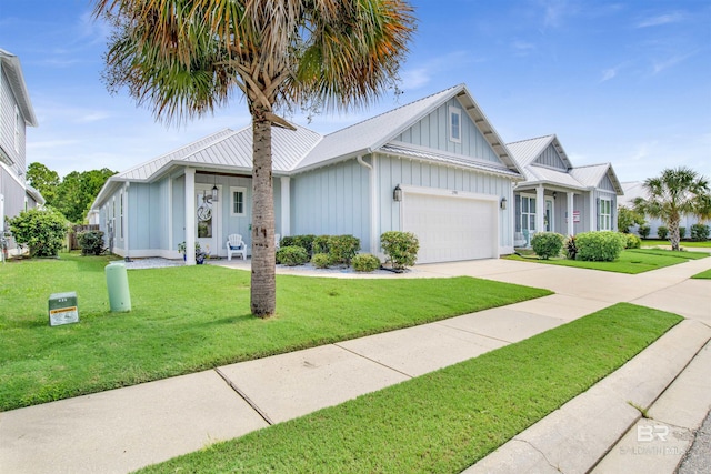 view of front of home with an attached garage, board and batten siding, a standing seam roof, metal roof, and driveway