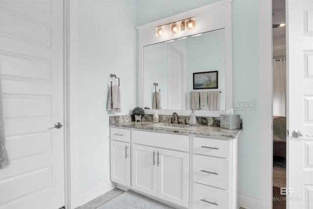 bathroom with vanity and baseboards