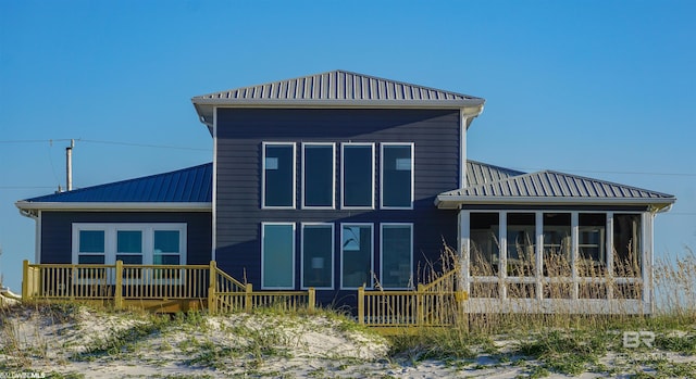 back of property with a sunroom