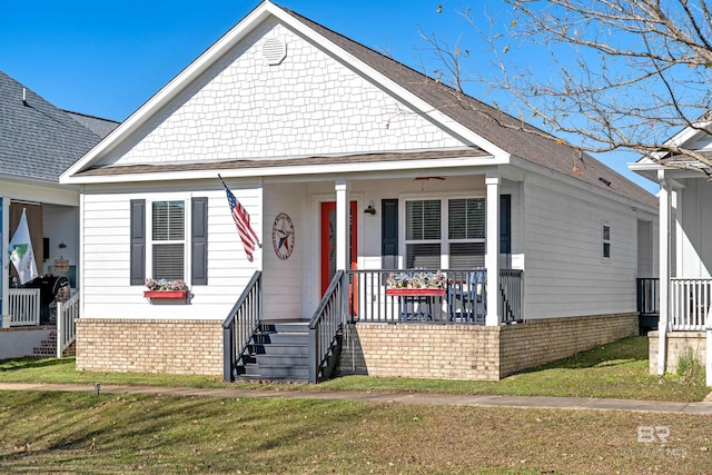 bungalow-style house featuring a porch and a front yard