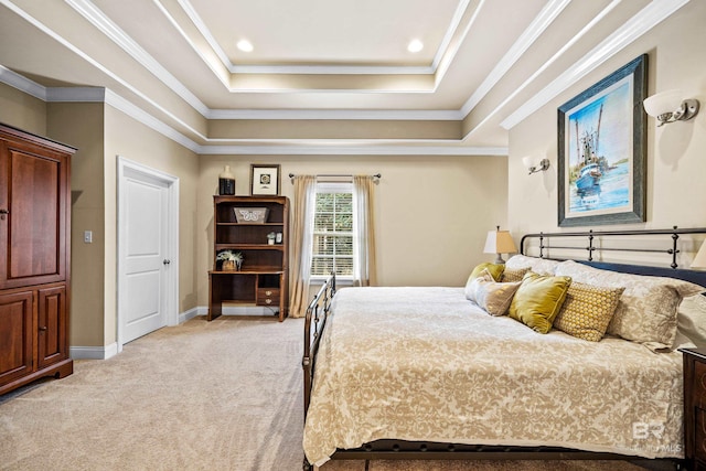 carpeted bedroom featuring ornamental molding and a tray ceiling