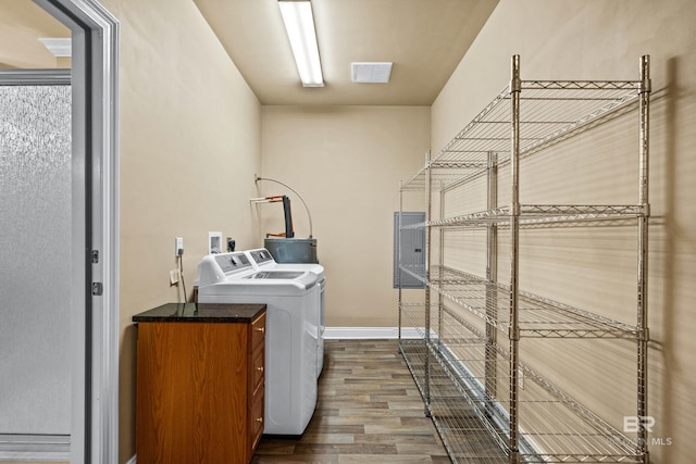 laundry room with wood-type flooring and separate washer and dryer