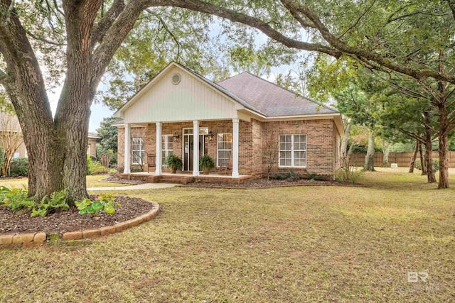 view of front of home with a sunroom and a front lawn