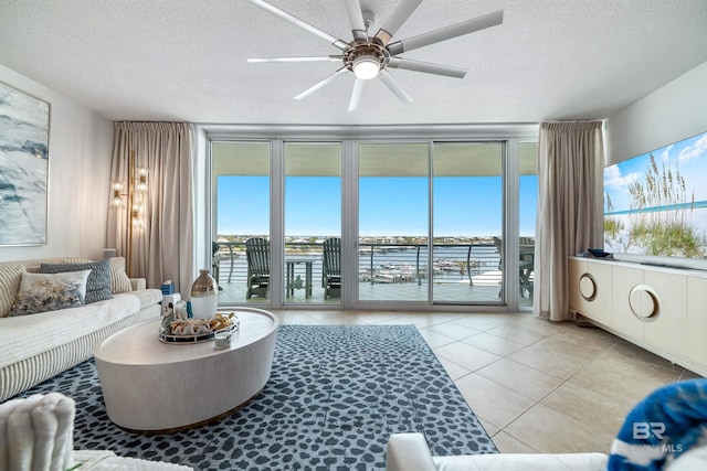 living area featuring a wealth of natural light, tile patterned floors, and expansive windows