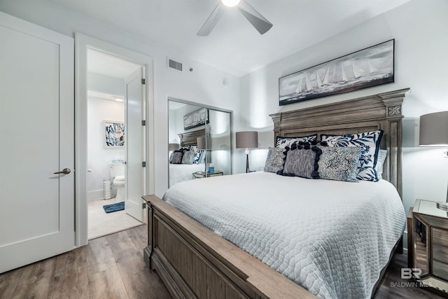 bedroom featuring a ceiling fan, connected bathroom, visible vents, and wood finished floors