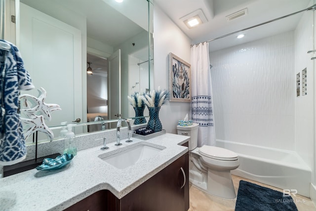 bathroom featuring toilet, vanity, shower / tub combo with curtain, visible vents, and ceiling fan