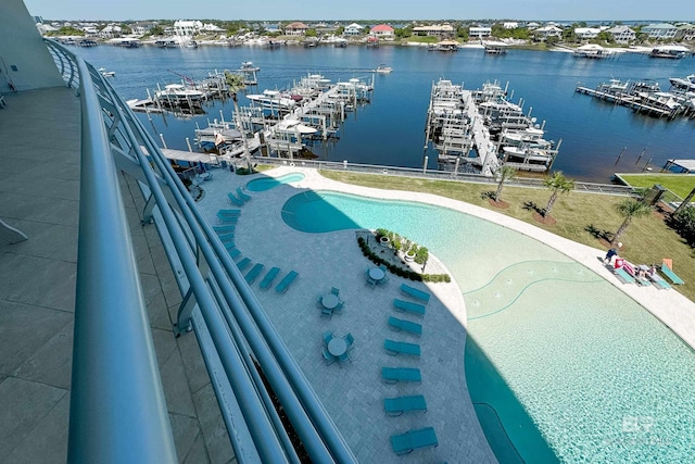 view of swimming pool with a water view