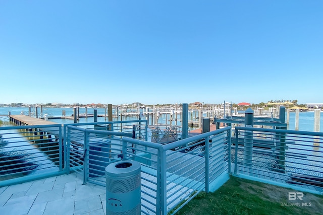 view of patio featuring a water view, a boat dock, and boat lift