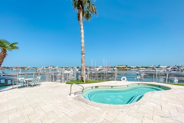 view of swimming pool featuring a water view and a patio