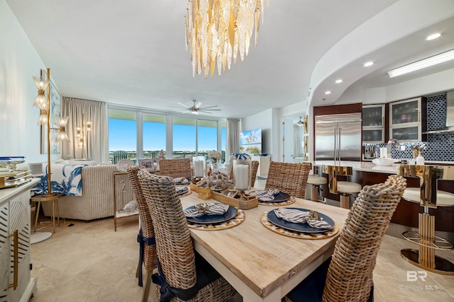 dining room featuring expansive windows, ceiling fan with notable chandelier, and recessed lighting