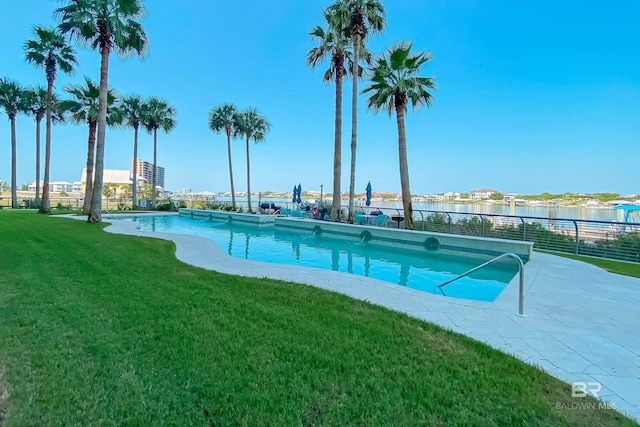 community pool with fence and a lawn