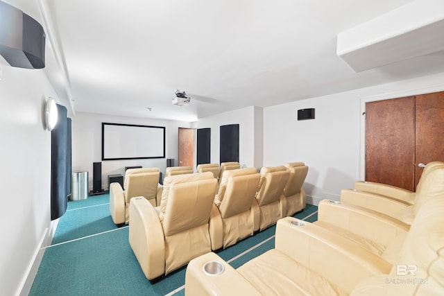 carpeted home theater room featuring baseboards