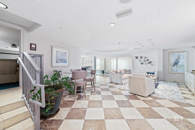 living area featuring recessed lighting, visible vents, and stairs
