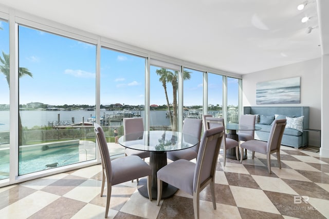 sunroom / solarium featuring a water view