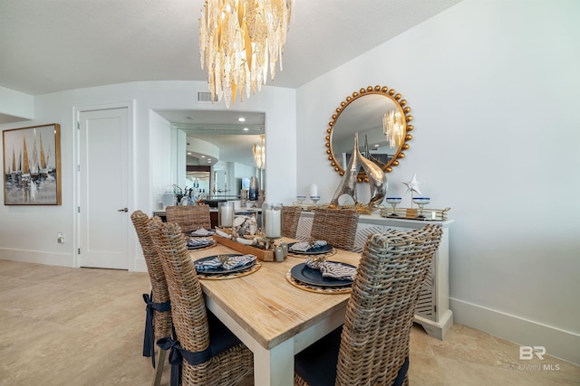 dining space with a chandelier, baseboards, visible vents, and tile patterned flooring