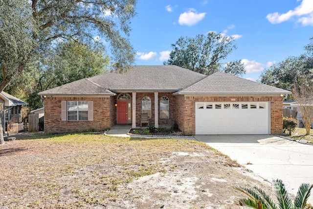 ranch-style house with concrete driveway, brick siding, an attached garage, and roof with shingles