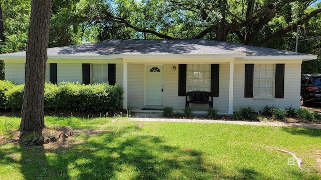 509 Pine St, Daphne, AL 36526 - ranch-style house with brick siding, covered porch, a front lawn, and a shingled roof