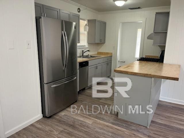 509 Pine St, Daphne, AL 36526 - kitchen with appliances with stainless steel finishes, gray cabinets, dark wood-style flooring, ornamental molding, and butcher block countertops