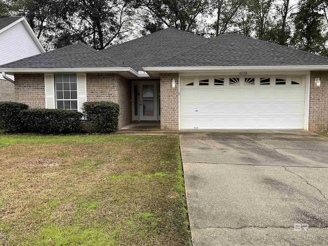 single story home with a front yard and a garage