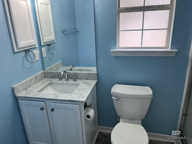 bathroom featuring vanity and toilet