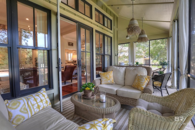 sunroom featuring vaulted ceiling