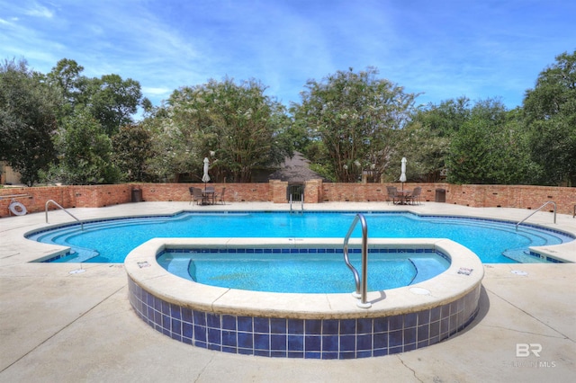 view of swimming pool with a community hot tub