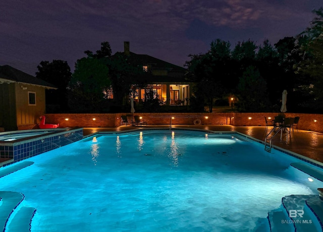 view of pool at night