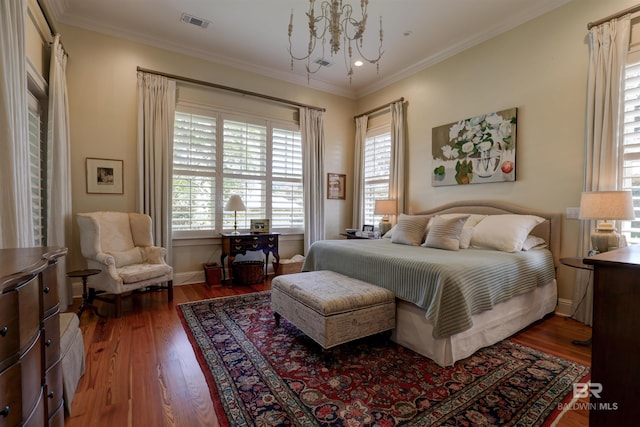 bedroom featuring crown molding, dark wood-type flooring, and an inviting chandelier