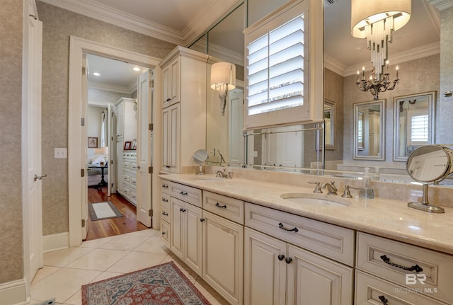 bathroom featuring tile patterned flooring, plenty of natural light, crown molding, and vanity