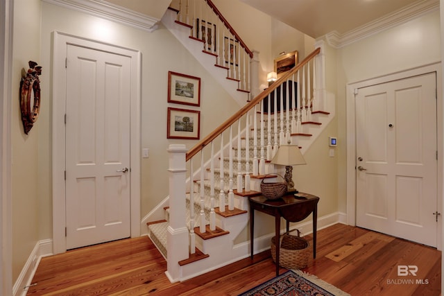 foyer featuring crown molding and wood-type flooring