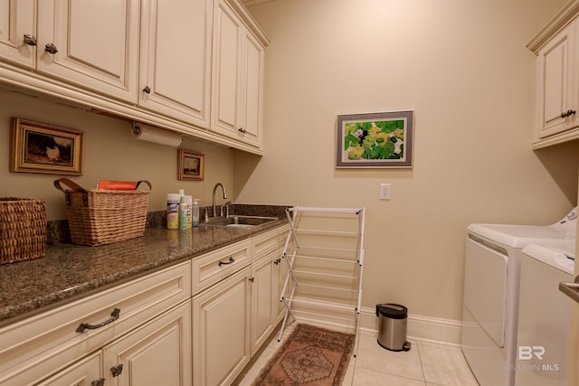 laundry room with sink, cabinets, separate washer and dryer, and light tile patterned floors