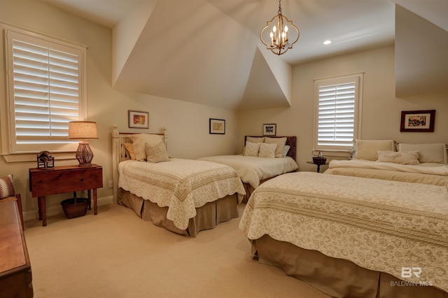 carpeted bedroom featuring an inviting chandelier